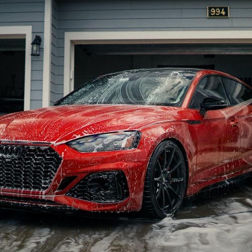 Audi RS5 covered in snow foam during a complete detail.