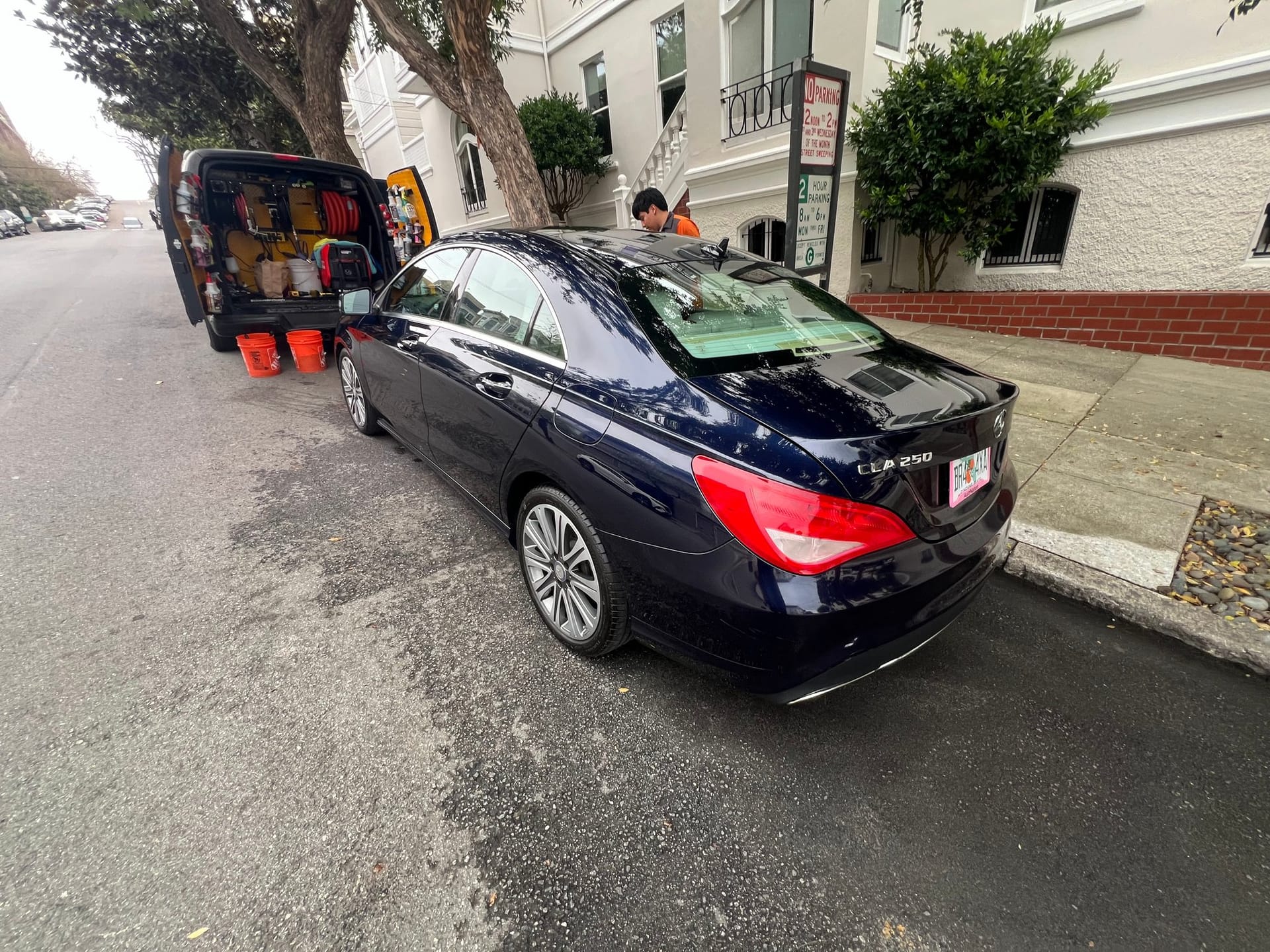 Mobile detailing service on location, luxury sedan.