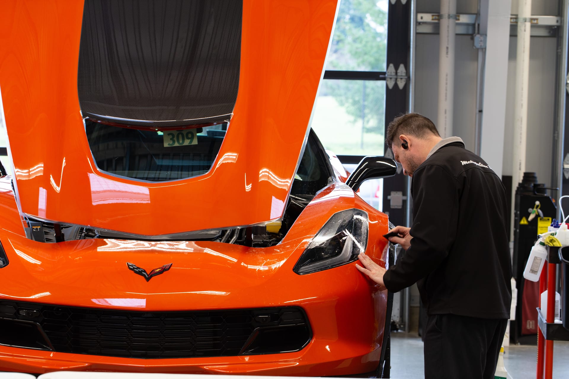 STEK installer applying DYNOshield to a Corvette Z06 headlight.