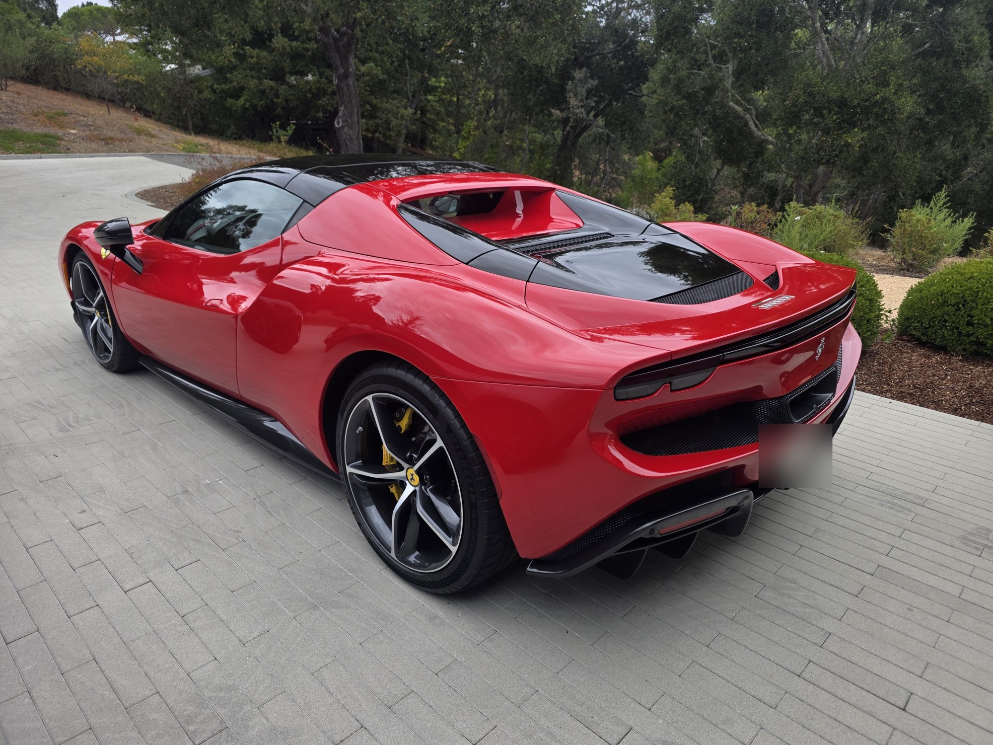 Rear three-quarter view of a red Ferrari 296 GTS after a P&S STOUT ceramic coating, engine cover and rear quarter in soft light.
