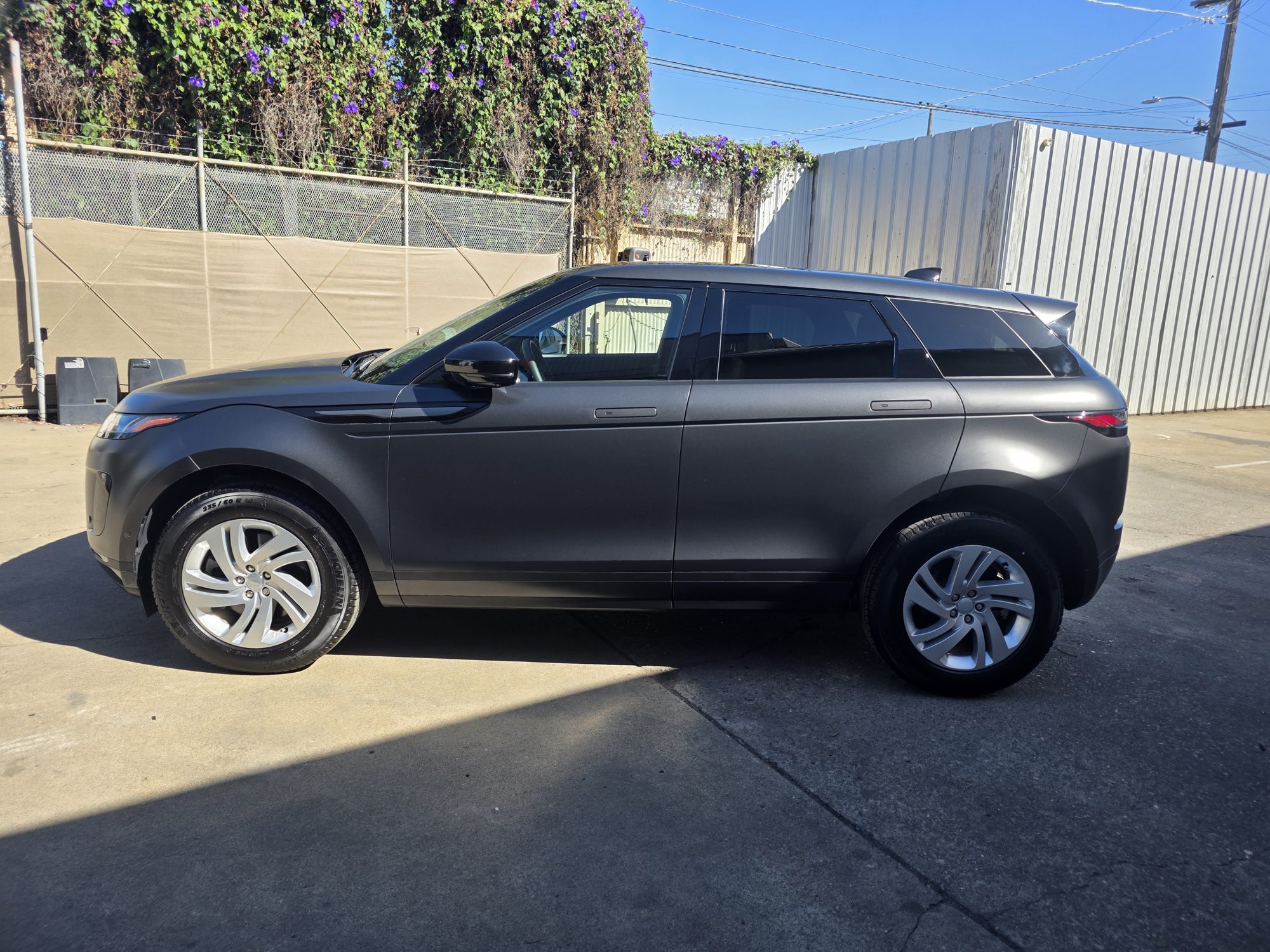 Range Rover Evoque in satin dark grey after a full-body STEK DYNOmatte paint protection film install, side profile outside the Innovo shop in Oakland.