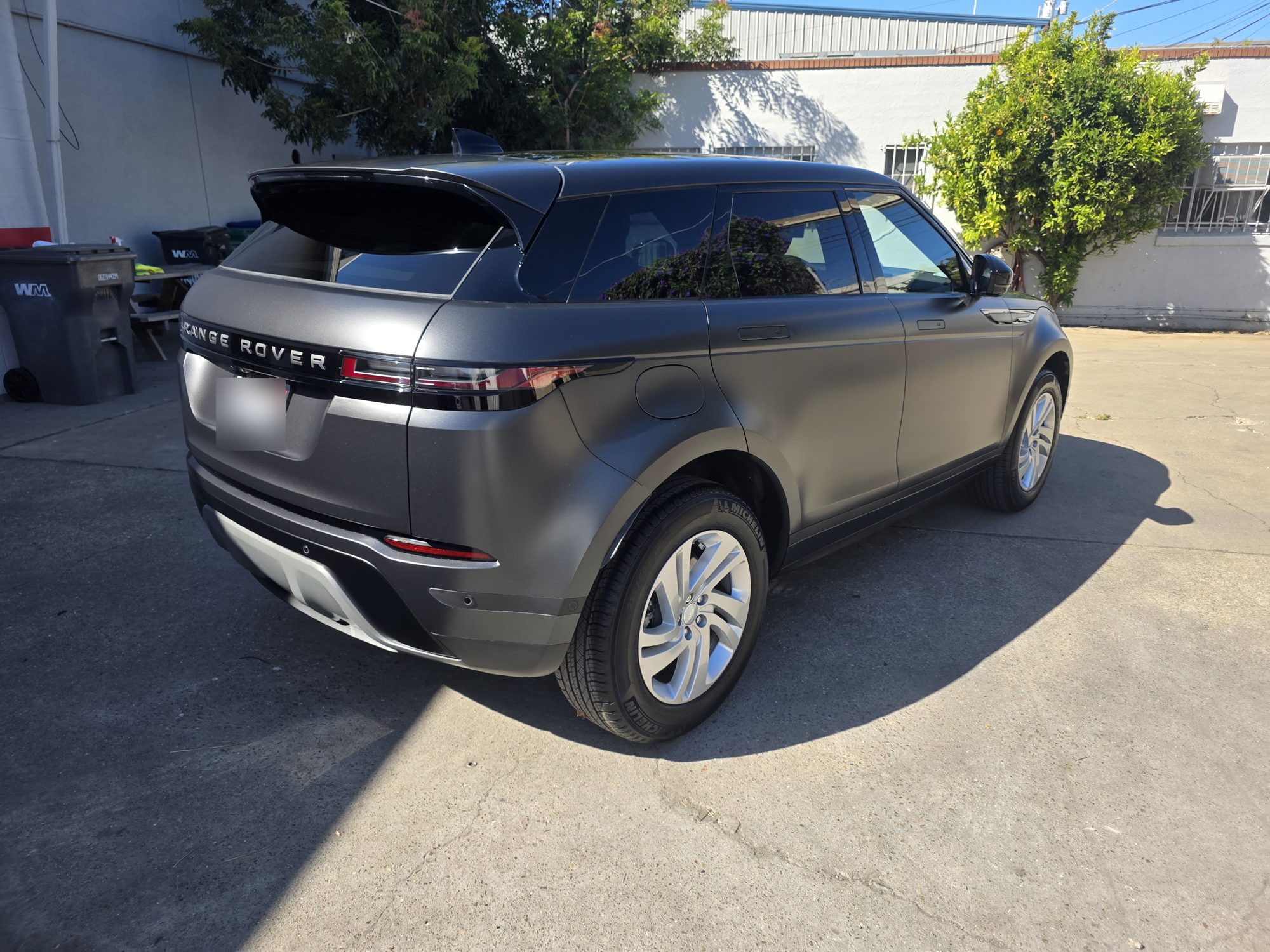 Range Rover Evoque in matte paint protection film photographed in direct sun, no gloss hot spots on the satin surface.