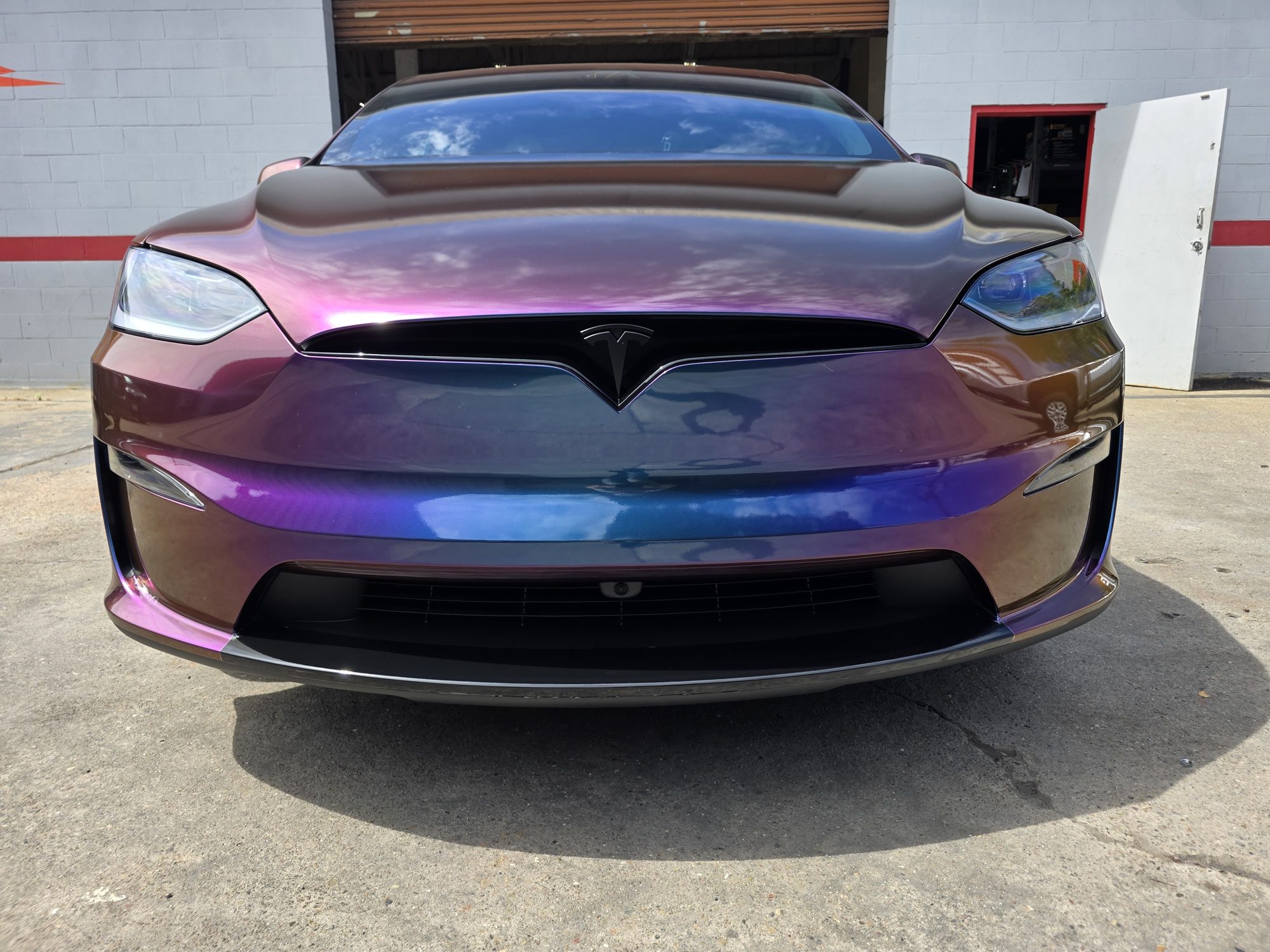 Straight-on front view of a colour-flip wrapped Tesla Model X with clear PPF over the wrap, the film invisible on the nose and hood.